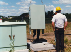 Photo of a fibercrete flat pad being installed with a transformer.