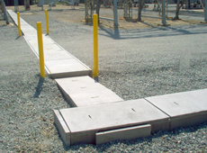 Photo of guide posts around Concast trench and covers.