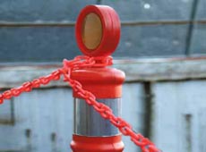 Photo of guide posts and chain around a transformer pad.